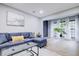 Inviting living room with a comfortable sofa, sheer curtains, and a decorative plant at 24317 Plantation Ne Dr, Atlanta, GA 30324