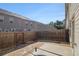 Fenced backyard with a concrete patio and an adjacent low-maintenance gravel area at 2721 Kemp Sw Ct, Conyers, GA 30094