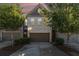 Charming townhome featuring a two-car garage and a welcoming brick facade surrounded by lush trees at 2721 Kemp Sw Ct, Conyers, GA 30094