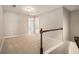 Brightly lit hallway with neutral carpet leading to multiple rooms at 2721 Kemp Sw Ct, Conyers, GA 30094