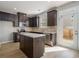 Modern kitchen with stainless steel appliances, granite countertops, and dark wood cabinetry with a door to the backyard at 2721 Kemp Sw Ct, Conyers, GA 30094