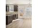Modern kitchen featuring a tile backsplash, stainless appliances, dark wood cabinets, and granite countertops at 2721 Kemp Sw Ct, Conyers, GA 30094
