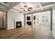 Inviting living room with coffered ceilings, wood floors, modern fireplace, and an open layout to the kitchen at 2721 Kemp Sw Ct, Conyers, GA 30094
