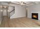 Spacious living room featuring a cozy fireplace, hardwood floors, coffered ceiling and staircase at 2721 Kemp Sw Ct, Conyers, GA 30094