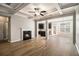 Inviting living area with hardwood floors, fireplace, coffered ceiling, and open access to kitchen at 2721 Kemp Sw Ct, Conyers, GA 30094