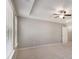 Spacious bedroom with ceiling fan, tray ceiling, and large windows at 2721 Kemp Sw Ct, Conyers, GA 30094