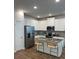 Stylish kitchen boasts white cabinetry, stainless steel appliances, and an island with bar stool seating at 4258 Sw Notting Hill Dr # 32, Atlanta, GA 30331