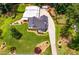 Aerial view showcasing a landscaped property with a long driveway and well-maintained lawns at 84 Ledbetter Rd, Villa Rica, GA 30180