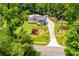 Aerial view of a charming home nestled within a lush, tree-filled landscape at 84 Ledbetter Rd, Villa Rica, GA 30180