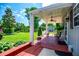Covered brick patio with outdoor furniture and lush green backyard view at 84 Ledbetter Rd, Villa Rica, GA 30180