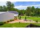 Backyard with a well-manicured lawn and inviting stone pathway leading to seating area at 84 Ledbetter Rd, Villa Rica, GA 30180
