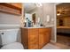 Practical bathroom featuring a sink, cabinet, toilet, and a view into the main bedroom at 84 Ledbetter Rd, Villa Rica, GA 30180