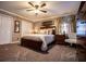 Well-lit bedroom featuring a plush bed, ceiling fan, and generous closet space at 84 Ledbetter Rd, Villa Rica, GA 30180