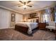 Comfortable bedroom with carpet flooring, a ceiling fan, and ample closet space at 84 Ledbetter Rd, Villa Rica, GA 30180