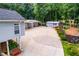 View of a home and long driveway, accented by manicured landscaping and a detached garage at 84 Ledbetter Rd, Villa Rica, GA 30180