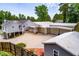 Expansive property with multiple garages, and a fenced yard surrounded by lush greenery at 84 Ledbetter Rd, Villa Rica, GA 30180