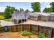 Charming two-story home with a well-manicured lawn and expansive driveway leading to a large detached garage at 84 Ledbetter Rd, Villa Rica, GA 30180