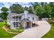 Expansive exterior featuring a wrap-around porch, a multi-car garage, and lush landscaping at 84 Ledbetter Rd, Villa Rica, GA 30180