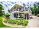 Charming exterior view featuring a spacious porch, landscaped gardens, and a garage at 84 Ledbetter Rd, Villa Rica, GA 30180