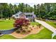 Landscaped front yard with retaining wall, vibrant trees and green lawn leads to the charming home at 84 Ledbetter Rd, Villa Rica, GA 30180