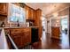 Charming kitchen with wood floors and cabinets, and open layout to the living space at 84 Ledbetter Rd, Villa Rica, GA 30180