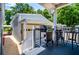 A covered patio with a grill and outdoor seating overlooking the yard at 84 Ledbetter Rd, Villa Rica, GA 30180