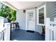 A covered porch with outdoor seating and a view of the landscaped yard at 84 Ledbetter Rd, Villa Rica, GA 30180