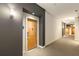 Hallway with wooden door and carpeted floors that show the entryway to a home at 870 Inman Village Ne Pkwy # 305, Atlanta, GA 30307