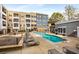 Community pool surrounded by lounge chairs with a multi-story building as the backdrop at 870 Inman Village Ne Pkwy # 305, Atlanta, GA 30307