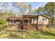 Exterior view of a home highlighting a wooden deck and landscaped backyard, perfect for outdoor entertaining at 2755 Austin Ln, Jonesboro, GA 30236