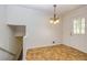 Open dining area with decorative chandelier and a tiled floor, leads to stairs at 2755 Austin Ln, Jonesboro, GA 30236