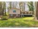 Charming split-level home featuring a welcoming front porch and a lush green lawn, perfect for outdoor enjoyment at 2755 Austin Ln, Jonesboro, GA 30236