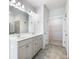 Bathroom with double sink vanity, neutral tile floor, and glass-enclosed shower at 2959 Rambler Dr, Loganville, GA 30052