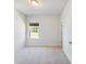 Bright bedroom features a window providing natural light and neutral carpet flooring at 2959 Rambler Dr, Loganville, GA 30052