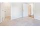 Light-filled bedroom with neutral carpet and closet and doorway to the bathroom at 2959 Rambler Dr, Loganville, GA 30052