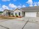 Exterior view of new construction townhomes, and two-car garage at 2959 Rambler Dr, Loganville, GA 30052