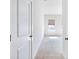 Hallway leading into a carpeted bedroom with a window providing natural light at 2959 Rambler Dr, Loganville, GA 30052