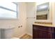 Bathroom with wood-look flooring, single dark wood vanity and a tile surround shower at 5170 2Nd St, Morrow, GA 30260