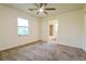 Bright bedroom with neutral carpet and attached bathroom with tiled shower at 5170 2Nd St, Morrow, GA 30260