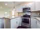 Modern kitchen with white cabinets, granite countertops, and stainless steel appliances at 5170 2Nd St, Morrow, GA 30260