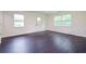 Bright living room with new, dark, wood-look flooring and fresh, neutral paint at 5170 2Nd St, Morrow, GA 30260