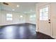 Bright living room with new, dark, wood-look flooring, modern recessed lighting at 5170 2Nd St, Morrow, GA 30260