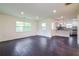 Open living room showing view to the kitchen with stainless steel appliances and granite countertops at 5170 2Nd St, Morrow, GA 30260
