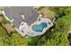 Aerial view showcasing an in-ground pool, jacuzzi, putting green and outdoor seating at 9315 Prestwick Club Dr, Johns Creek, GA 30097