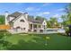 Stunning backyard featuring a putting green, outdoor kitchen, and a sparkling pool at 9315 Prestwick Club Dr, Johns Creek, GA 30097