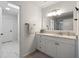 Bright bathroom vanity with marble countertop and view to a hallway with a clean, white aesthetic at 9315 Prestwick Club Dr, Johns Creek, GA 30097
