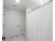 White bathroom with shower, toilet, and skylight at 9315 Prestwick Club Dr, Johns Creek, GA 30097