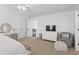 Bright bedroom featuring stylish accent wall, modern dresser, and comfortable seating area at 9315 Prestwick Club Dr, Johns Creek, GA 30097