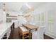 Charming dining area featuring a rustic table and bench, with bright natural light from shuttered windows at 9315 Prestwick Club Dr, Johns Creek, GA 30097
