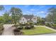 Charming two-story home boasting lush greenery, manicured bushes and a curved driveway at 9315 Prestwick Club Dr, Johns Creek, GA 30097